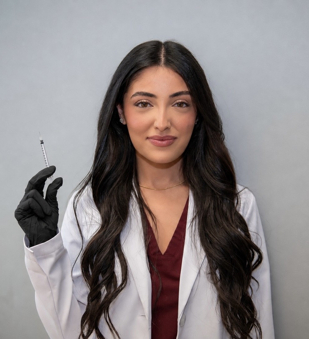 Rina, Physician Assistant, holding a syringe