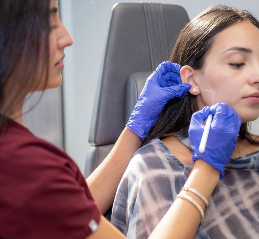 Rina examining the ear and jaw area